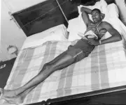 American basketball player Wilt Chamberlain reads a book while spr- Old Photo