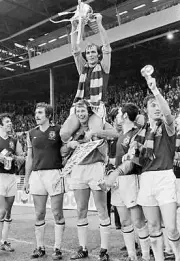 Aston Villa captain Ian Ross holding the trophy aloft whilst sitti- Old Photo