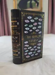 The Book Of Eyes Metal Book Tin inspired by Sorcery Of Thorns - Illumicrate