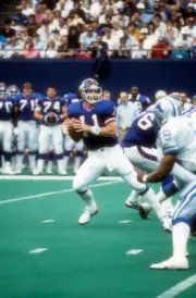 Quarterback Phil Simms of the New York Giants drops back to pass - Old Photo
