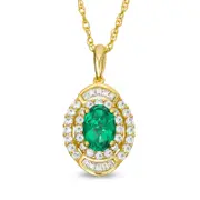 Oval Emerald and 0.33 CT. T.W. Natural Diamond Double Frame Pendant in 10K Yellow Gold