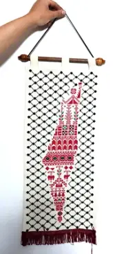 A Palestinian hand-embroidery hanging board with a picture of the map of Palesti