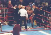 Referee Mills Lane confers with Mike Tyson at a bout against Evand- Old Photo