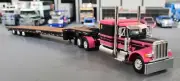 1/64 DCP PETERBILT 389 PINK & BLACKWITH TRI AXLE TILTING TRAILER 60-1444