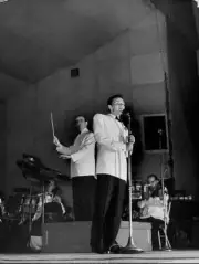 Singer Frank Sinatra rendering a song as conductor Max Steiner- 1940s Photo 3