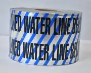 Buried Reclaimed Water Line Below Black Worksite Safety Barricade Tape 6"x1000'
