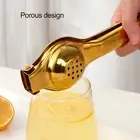 A ORANGE AND LEMON SQUEEZER JUICER HAND PRESS AND JAR OPENING PLIARS