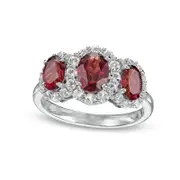 Oval Garnet and White Lab-Created Sapphire Frame Three Stone Ring in Sterling Silver