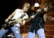 Joe Don Rooney of Rascal Flatts jams with fiddler John Johnson as - Old Photo