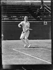 Harry Hopman watching the tennis ball after hitting a shot during - Old Photo