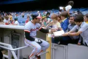 Outfielder Reggie Jackson Baltimore Orioles signs autographs for - 1976 Photo