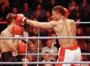Michael Watson of England lands a right hand on Craig Trotter of A- Old Photo