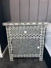 bedside table, bone inlay, black and white geometric pattern.