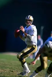 Quarterback Bobby Hebert New Orleans Saints drops back to pa- Football Photo 1
