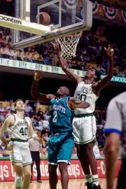 Robert Parish Boston Celtics goes up for a rebound v Larry Johnson- Old Photo