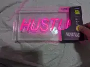 Hustle Pink Neon Light With power cord and on and off switch on the cord.