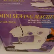 MINI SEWING MACHINE JYSM 202A with accessories. A8
