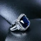 Lab Created Emerald Cut Blue & White Colorless Gemstone With Halo Style Ring