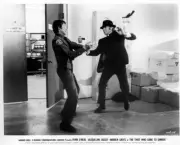 Ryan O'Neal as Webster McGee confronts a security guard in a scene- Old Photo