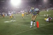 Running back Skip Hicks UCLA Bruins looks down at the sideline to - Old Photo