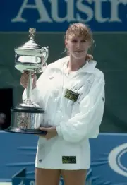 Steffi Graf of Germany poses with the trophy after defeating Mary - Old Photo