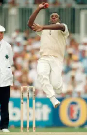Devon Malcolm bowling for England during the 6th Test match b- Old Cricket Photo
