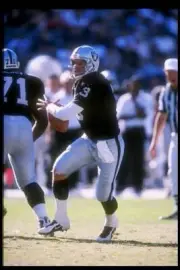 Quarterback Jeff George Oakland Raiders looks for an open pass at - Old Photo