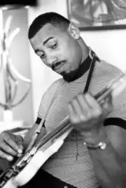 Philadelphia 76ers Wilt Chamberlain casual playing guitar in his a- Old Photo