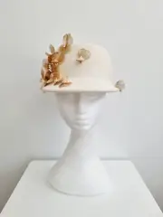 Miss Dominica. Womens Ivory wool felt cap with gold metal floral detailing