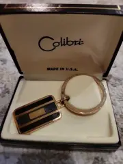 New Old Stock Colibri Gold Tone W/Black & Gray Color Key Chain