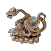Pewter Dragon sitting with two Clear Crystal Spheres.