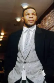 Mike Tyson poses for a photo while fitted for a suit during a phot- Old Photo 4