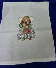 FINISHED CROSS STITCH ANGEL HOLDING LARGE GINGERMAN AND CARRYING BASKET
