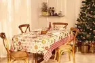 Christmas holiday tablecloth in cream and red with ornaments and snowflakes
