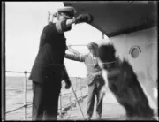 Ship captain playing with a dog on a ship, Lord Howe Island, NSW, - Old Photo