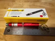 Renegade Laser Green Key Chain USB Charging Laser Pointer In A Red Housing.