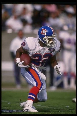 Running back Glyn Milburn Denver Broncos runs with the ball at a - 1994 Photo 1