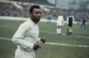 Brazilian footballer Pele on the pitch prior to the match between - Old Photo