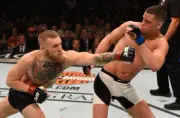 Conor McGregor punches Nate Diaz at UFC 196, 2016 7x5 Photo