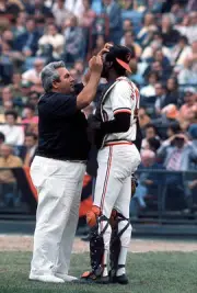 Elrod Hendricks Baltimore Orioles is looked at by the team traine- 1974 Photo