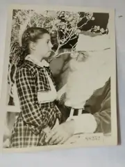 Vintage classic 1940 Photo of Santa Clause and Little Girl Standing biting tongu