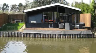 Modern chalet in a small park located right along a fishing pond