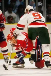 The New Jersey Devils' Kirk Muller checks the Washington Capit Hockey 1988 Photo