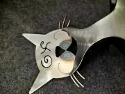 Metal Cat Wine Bottle Holder. Has a Drunk face with X on his eye.