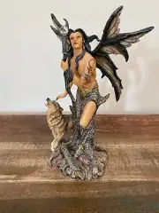 Male fairy figurine with wolf