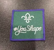 # You Shape Scout Badge Green With Purple Edges