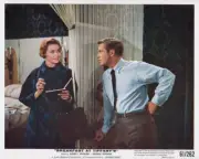 Patricia Neal writing in book while talking with George Peppard in- Old Photo