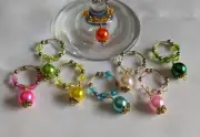 Set of 8 wine glass rings made with memory wire and beads.