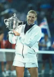 Steffi Graf of Germany poses with the trophy as the rain falls Aft- Old Photo