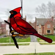 Handmade Stained Glass Red Cardinal Suncatcher standing on a branch